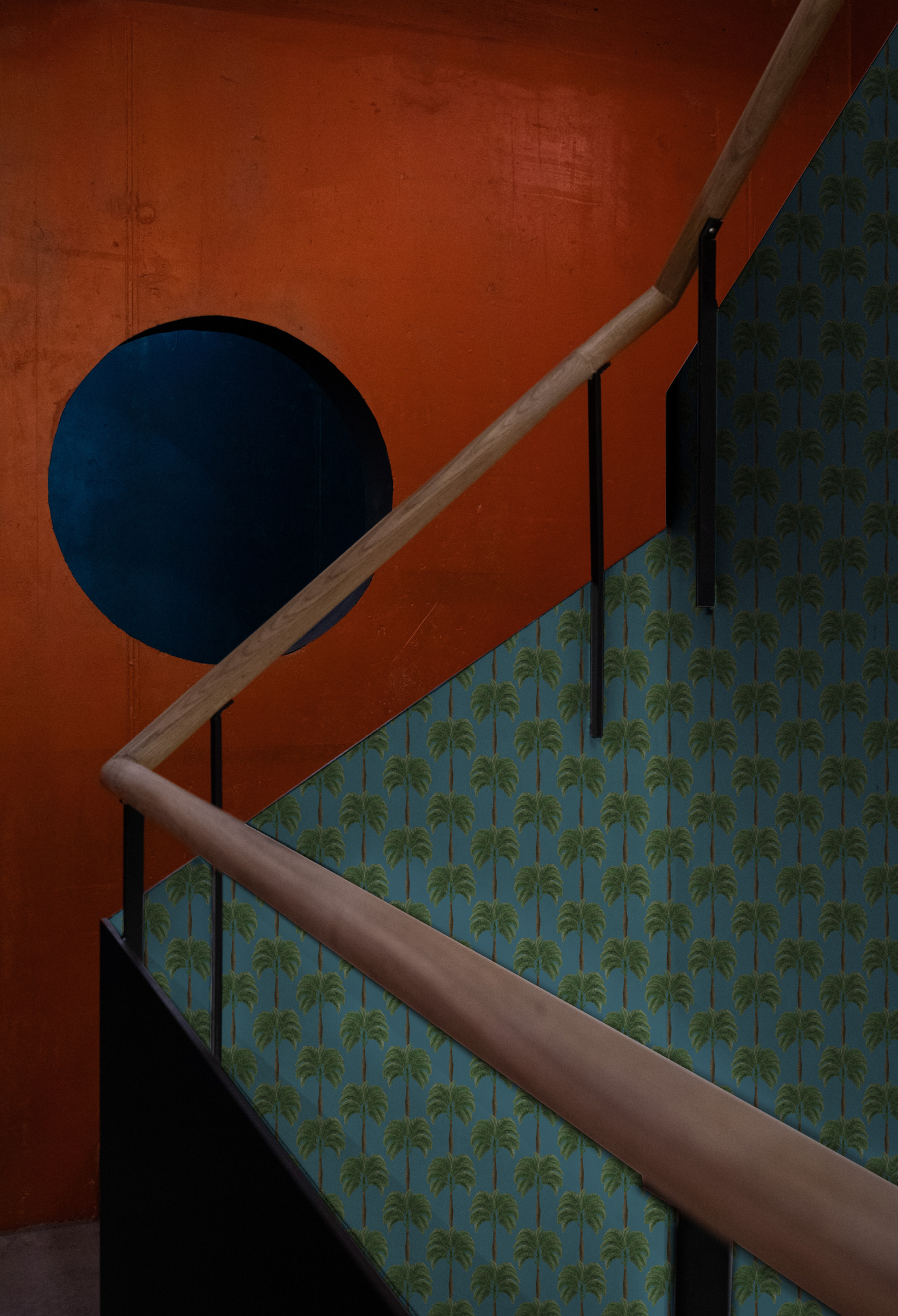 A modern hall palm tree patterned Luxury Deus ex Gardenia Little Palma Wallpaper in Lagoon on the staircase. photographed by Pascal Meier.