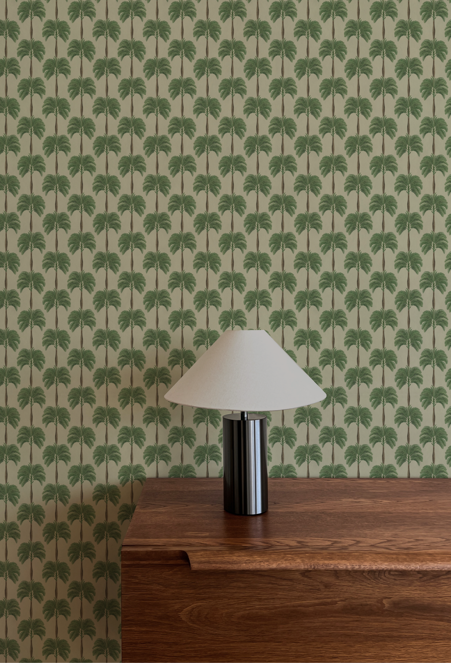 A room with a table and lam with luxury palm painted patterned Wallpaper of Little Palma in Sand from Deus ex Gardenia. Photo by MK-S.
