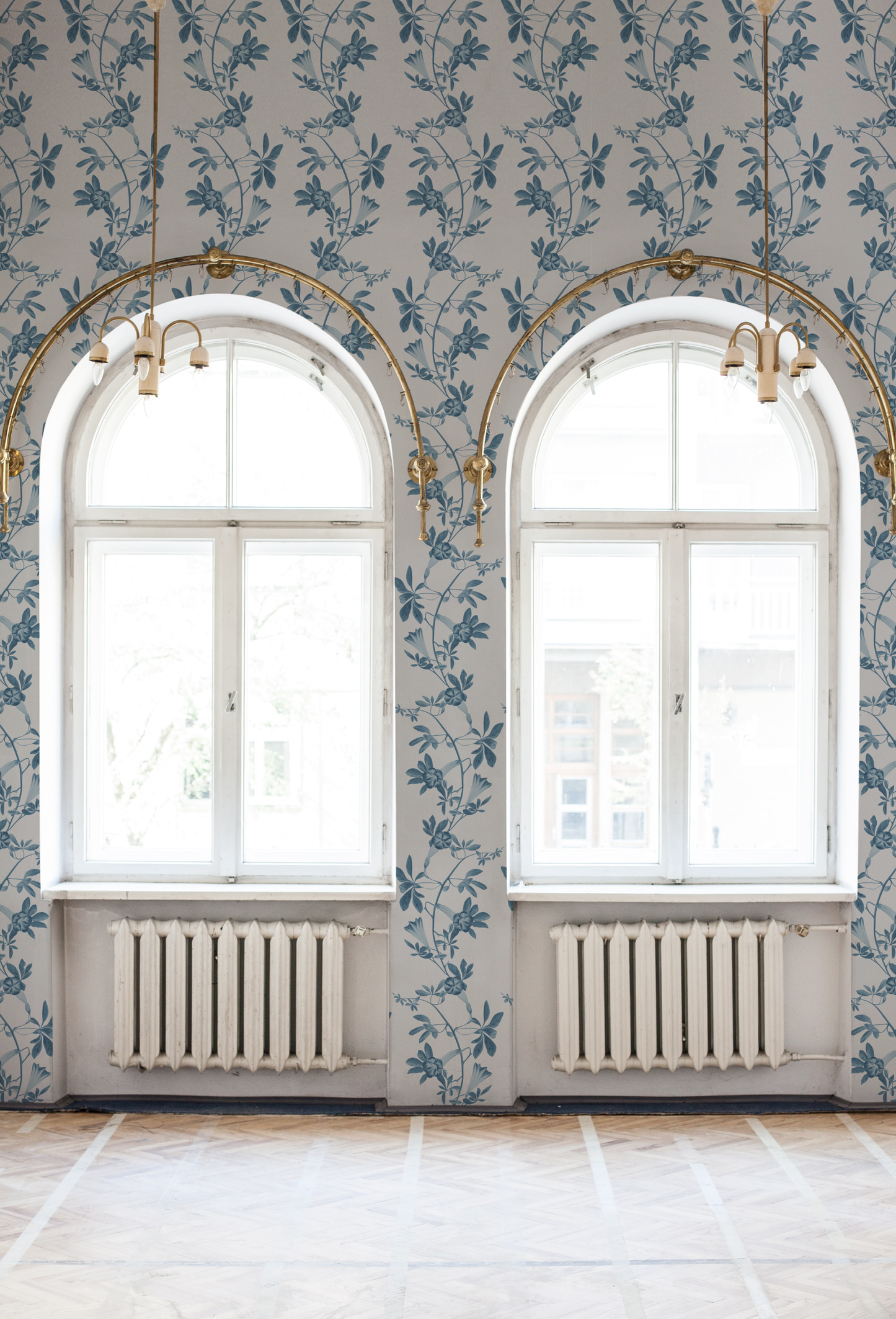 Blue floral striped wallpaper in a room with large oval windows featuring the Midsummer in Iris from Deus ex Gardenia. Photo by Katie Luka.