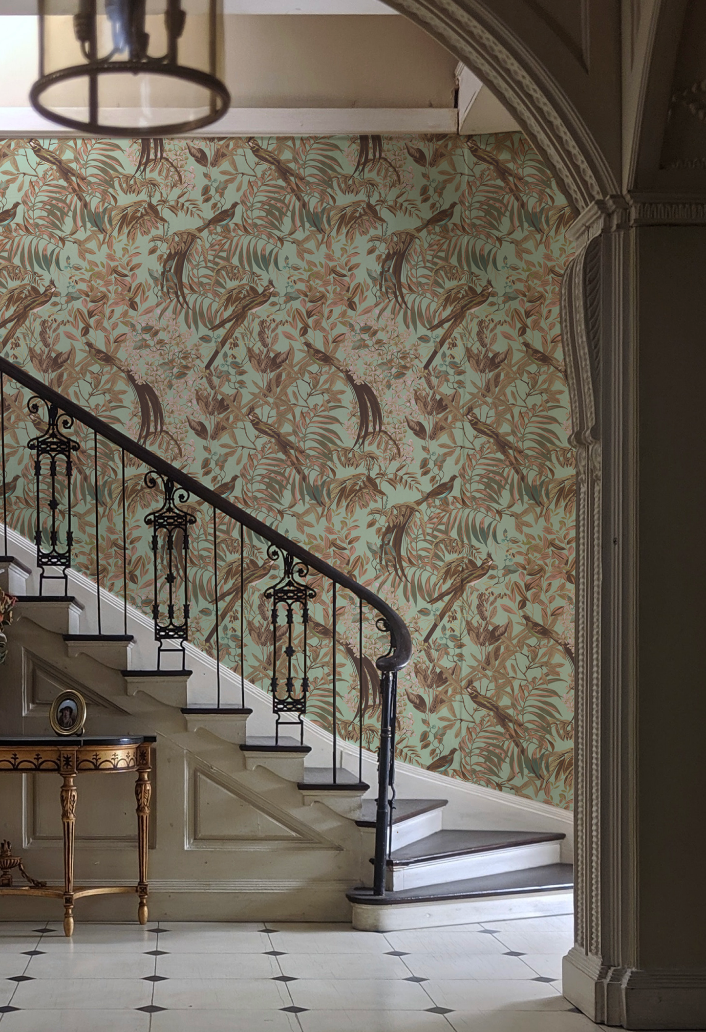 Glamorous hall with antique staircase featuring Deus ex Gardenia's botanical 'Resplendent Woods' Wallpaper in Teal. Photo by Jack Kolpitck.